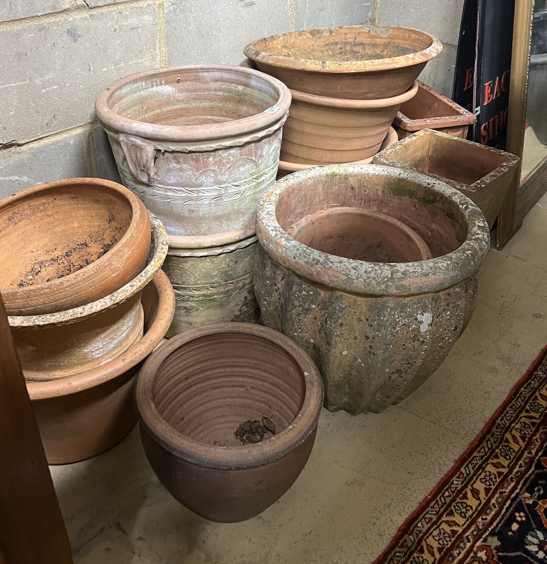Fourteen assorted terracotta garden planters, largest diameter 42cm, height 40cm